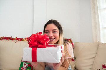 Hispanic woman surprised by a Christmas gift