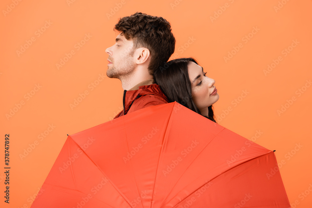 Sticker fashionable man and woman near umbrella isolated on orange