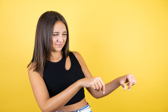 Beautiful Young Girl Kid Over Isolated Yellow Background Disgusted Expression, Displeased And Fearful Doing Disgust Face Because Aversion Reaction. With Hands Raised. Annoying Concept