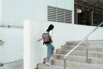 University student walking up stair.