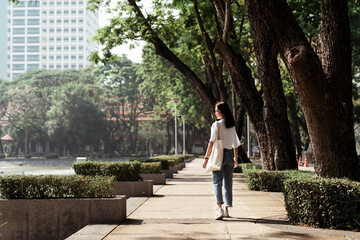 Fototapeta na wymiar University student walking in the park.