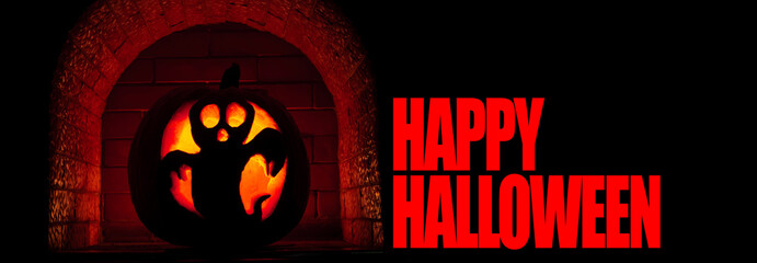 Close-up of Happy Halloween text and orange glowing pumpkin, isolated on black background.