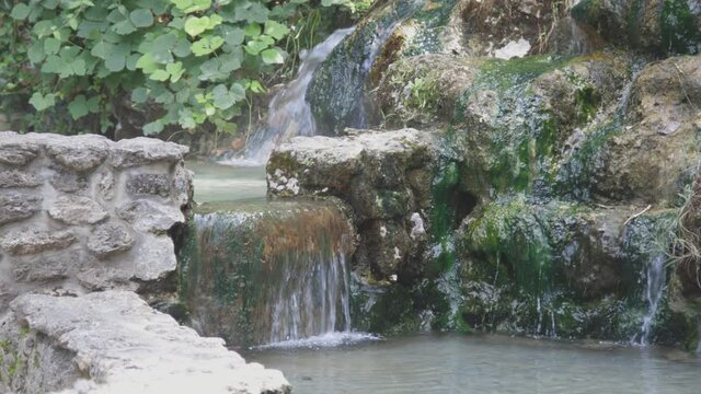 Hot water spring flowing and falling into a pool