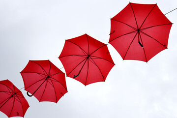 Red umbrellas hanging in the air