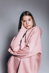 Close up teen girl portrait isolated on grey background with flowers, young beauty brunette asian girl