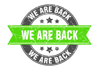 Obraz premium we are back round stamp with ribbon. label sign