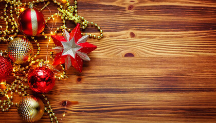 Christmas composition. Christmas red and gold decorations on a wooden background. Flat lay, top view, copy space