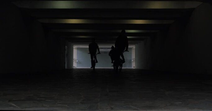 bmx guys bikers ride through foot tunnel