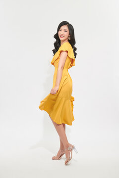A beautiful girl in a light yellow dress. Charming light style