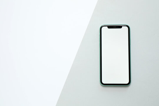 MYKOLAIV, UKRAINE - JULY 07, 2020: iPhone 11 on color background, top view. Mockup for design