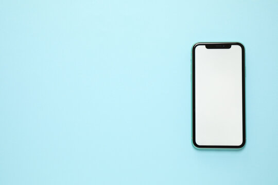 MYKOLAIV, UKRAINE - JULY 07, 2020: iPhone 11 on light blue background, top view. Mockup for design