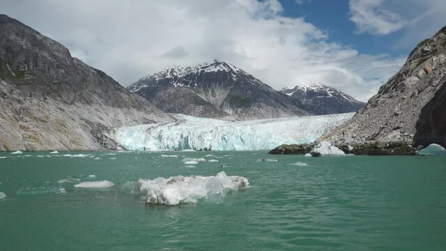 Dawes Glacier with Mountains Behind and Floating Bergy Bit in  Tracy Arm Fjord, Southeast Alaska