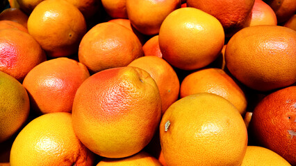 Heap of grapefruits on a fruit market - close up