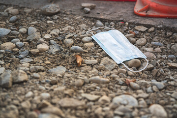 Protective mask disposed of on the street during the Corona crisis