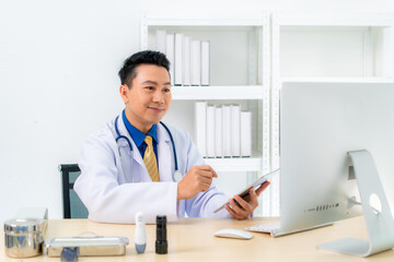 Smiling Asian doctor with digital tablet looking at camera. Remote online medical chat...