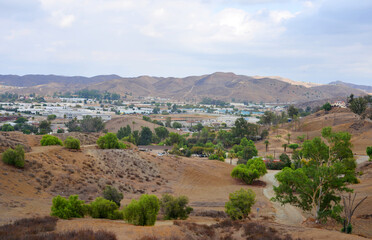 Fototapeta na wymiar Lake Elsinore, California, USA, panoramic view over a industrial area and distant hill landscape