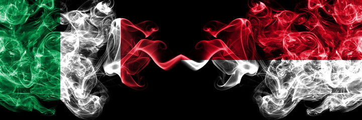 Italy vs Monaco, Monacan smoky mystic flags placed side by side. Thick colored silky abstract smoke flags of Italian and Monaco, Monacan