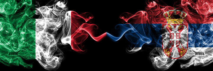 Italy vs Serbia, Serbian smoky mystic flags placed side by side. Thick colored silky abstract smoke...