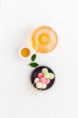 Japanese food background with sweets and tea. Three colored dumplings Dango