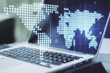 Double exposure of abstract digital world map on laptop background, research and strategy concept