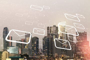 Abstract virtual postal envelopes sketch on Los Angeles office buildings background, e-mail and marketing concept. Double exposure