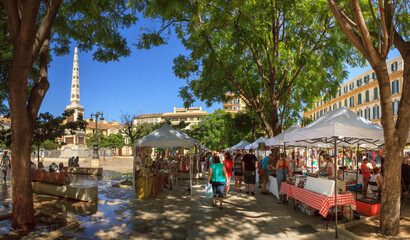 Malaga, Spain: summer market at Plaza de la Merced in the old town, on a cloudless day, with rows...