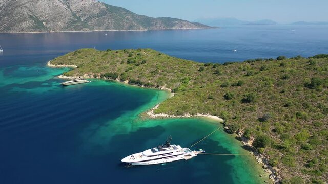 Aerial drone video of beautiful paradise bay and secluded beaches of Skinos covered in pine trees in beautiful Ionian island of Ithaki or Ithaca, Greece