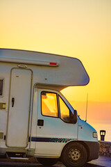 Camper car on coast at sunrise