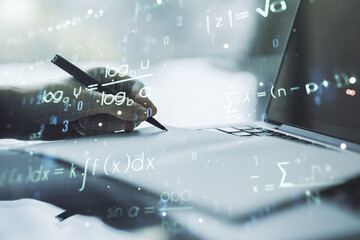 Creative scientific formula concept with hand writing in notebook on background with laptop. Multiexposure