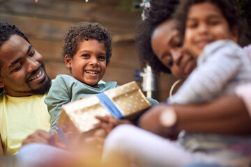 close up of  afro-american family at birthday party, sitting and smiling together