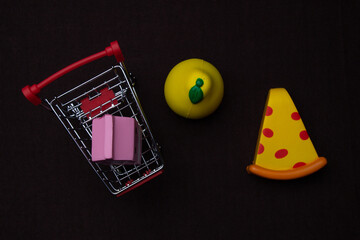 Toy plastic fruits and food isolated on black backgound