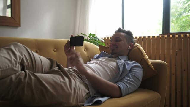 Male millennial professional holding modern smartphone texting message