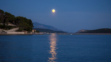 Full moon over tha bay of Banjol on island Rab in Croatia
