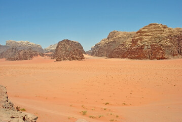 Fototapeta na wymiar Sandstone rocks and sand in Wadi Rum desert, Jordan