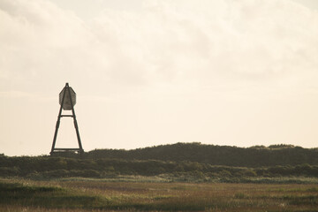 Naklejka premium The beacon on Amelend, A cape or sea cape is a beacon for shipping and is a striking landmark in the landscape. on the beautiful Oerd, protected nature area on Ameland, the Netherlands