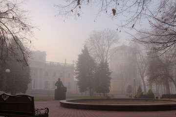 cozy benches in a city foggy park in the fall. Gomel, Belarus