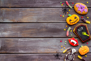 Overhead view of Halloween decorations with cookies and candies, top view
