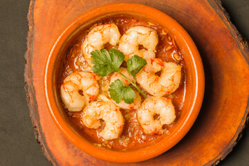 Tot view of prawns in a bowl on a wood.