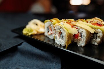 Golden dragon sushi roll with tuna, eel, cucumber, sesame seeds and tobiko caviar.