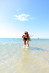 Fototapeta na wymiar Woman enjoying her holidays at the tropical beach. Happy young woman enjoys her beach vacation
