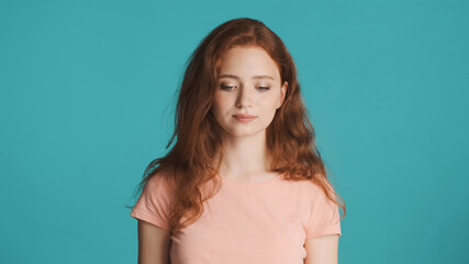 Beautiful dreamy girl closing eyes on camera over colorful background