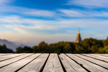 Showcase an old wooden table shelf on the natural scenery and blurred natural background.	