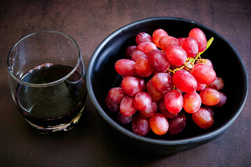 Red delicious fresh grapes with red wine