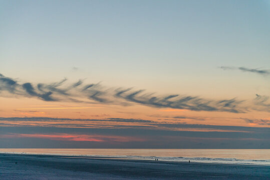 Beautiful sunset with some clouds on the beach of Ameland in the Netherlands, beautiful color nature photo
