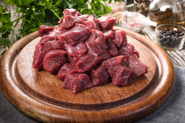 Beef stew prepared on a chopping board.