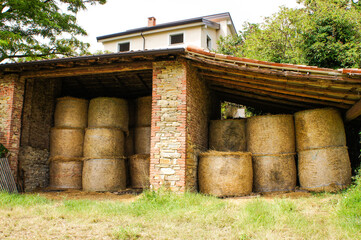 old rural house with  hay bales