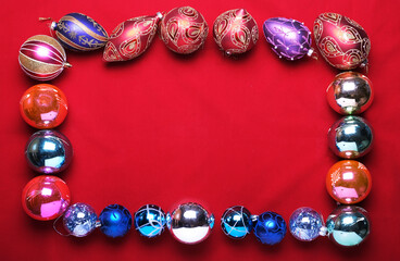 balls, multicolored Christmas toys on a red background