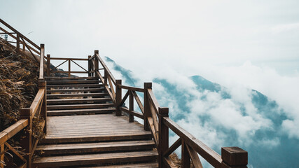 Wooden path with view of mountain covered by clouds on Wugong Mountain in Jiangxi, China