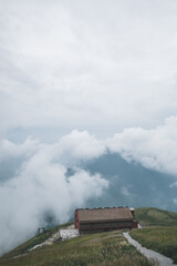 Path leading to house overlooking mountains covered by clouds on Wugong Mountain in Jiangxi, China