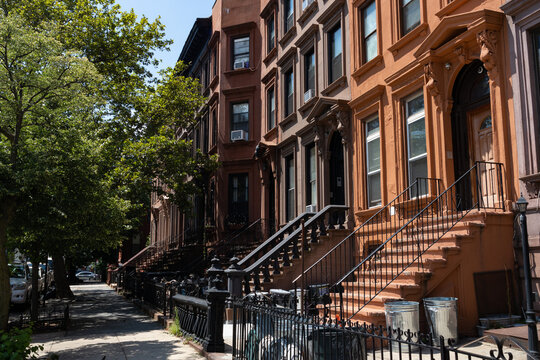Row of Old Brownstone Homes in Bedford-Stuyvesant in Brooklyn of New York City along an Empty Sidewalk